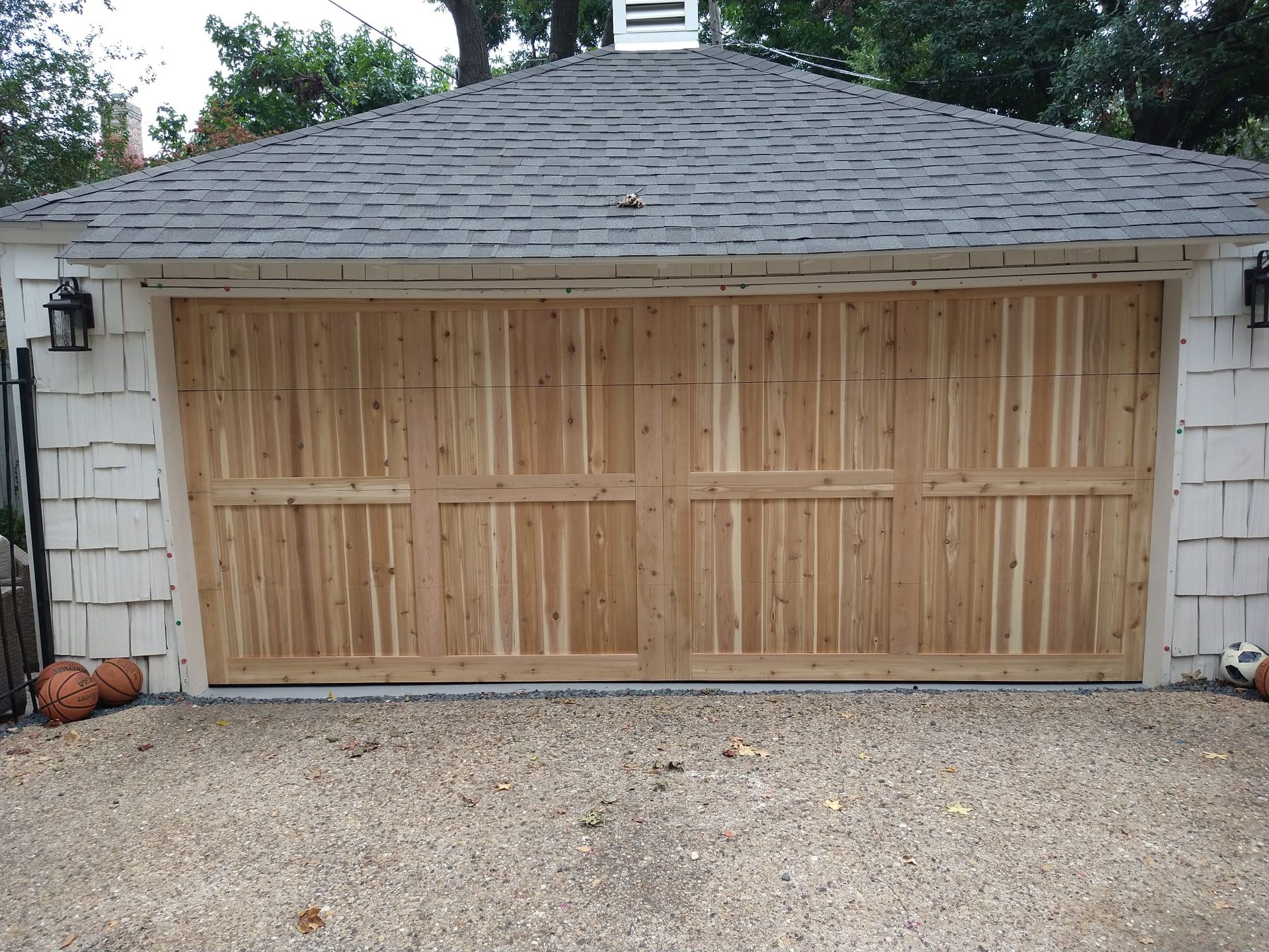 A white garage with a wooden garage door