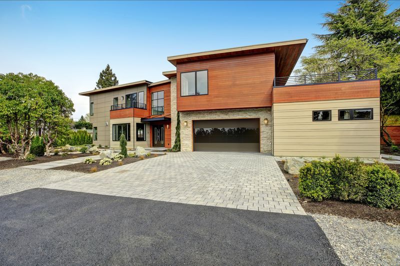 A large house with a garage and a driveway in front of it.