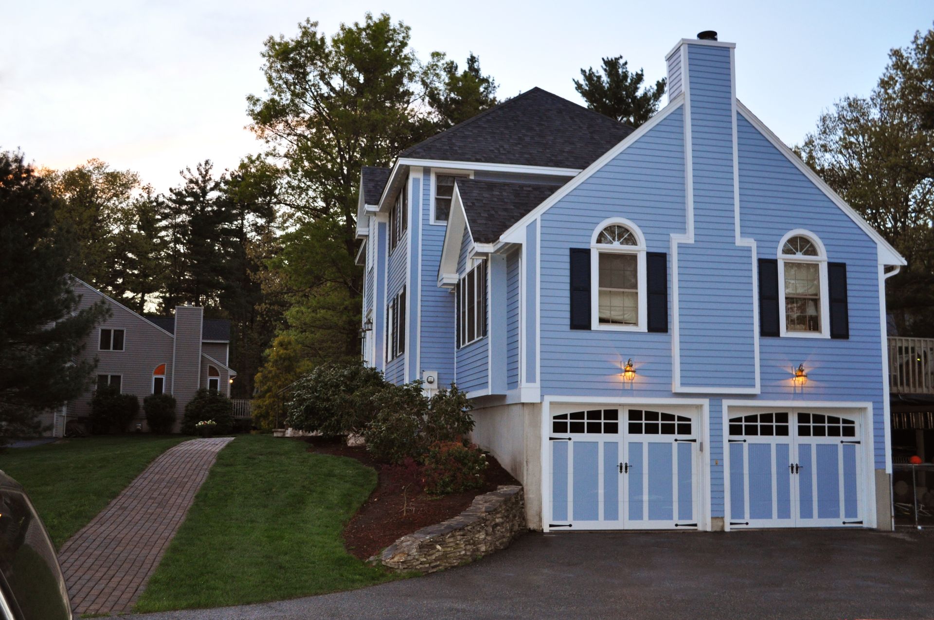 A blue house with white trim and black shutters