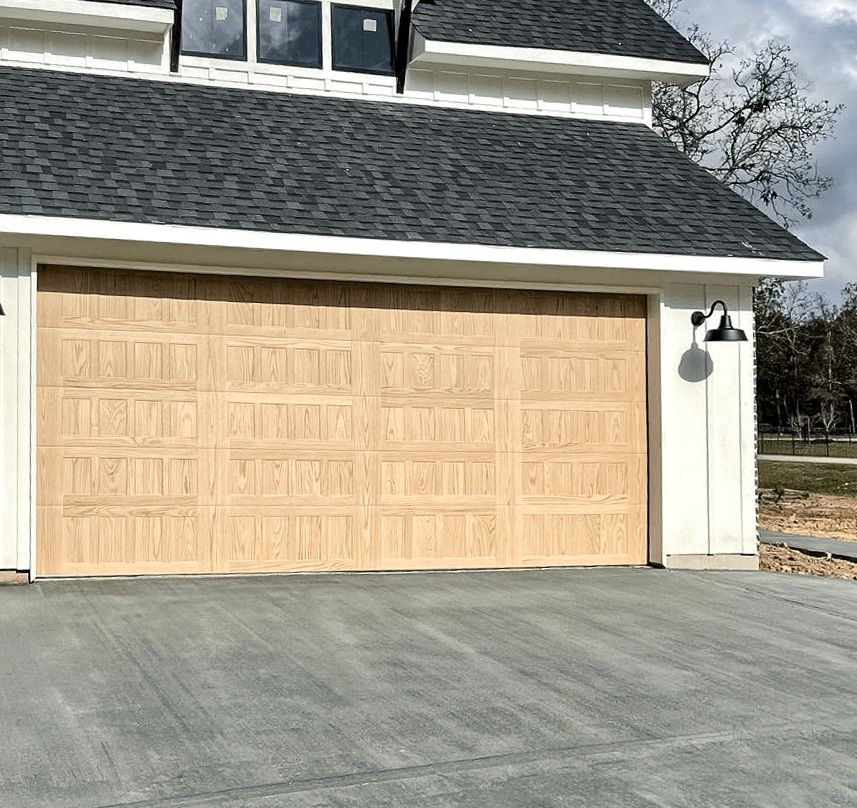 A white house with a large wooden garage door