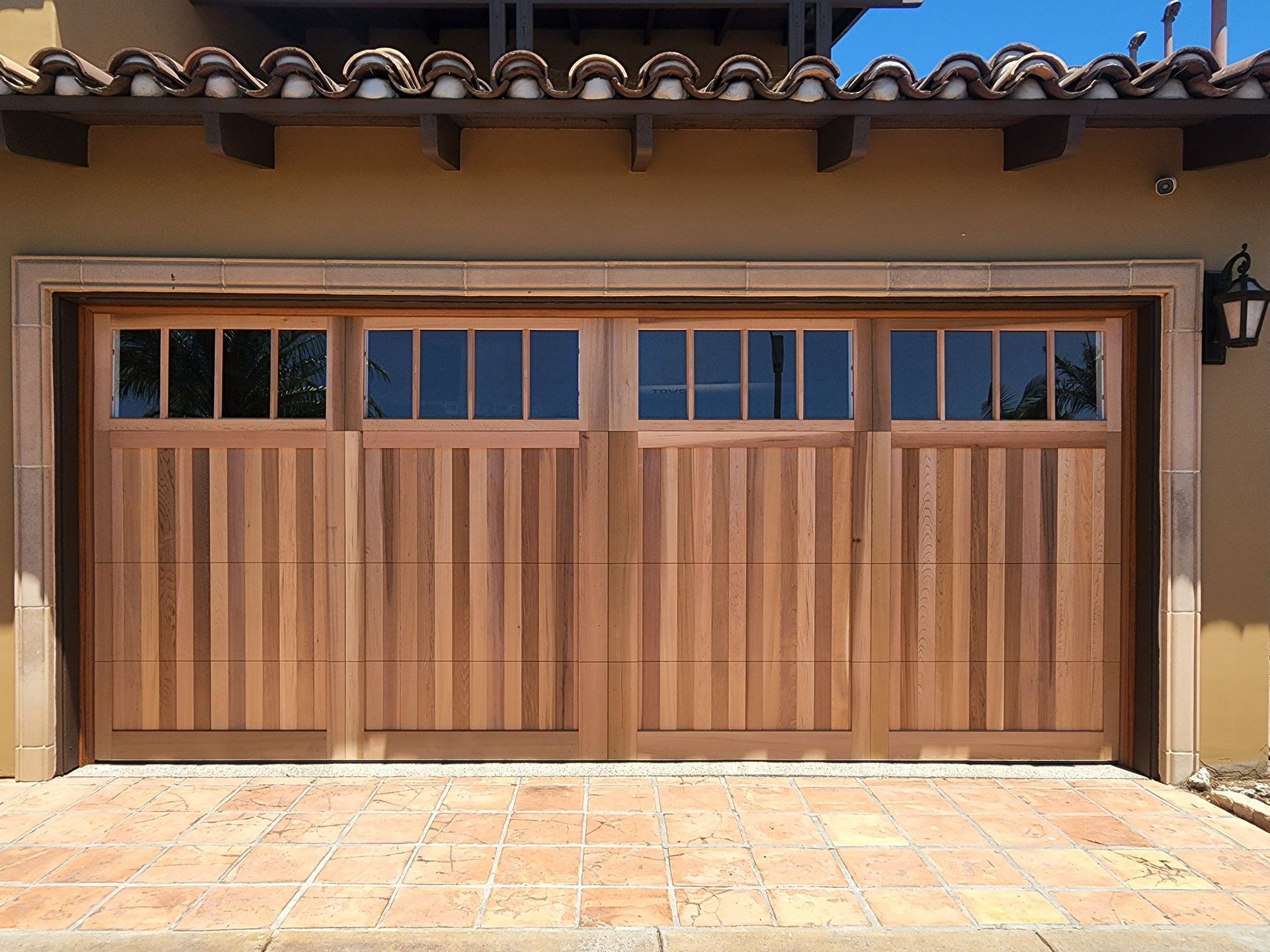 The garage door is made of wood and has a lot of windows.