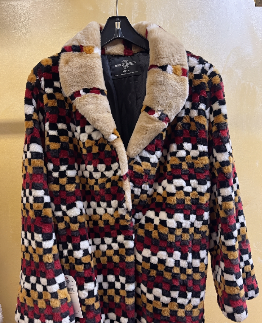 Checkered multi-color fur coat with a plush tan collar displayed at USA Furs by George Manhattan