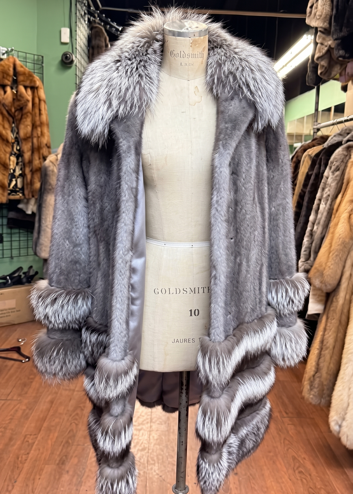 Gray faux-fur coat with striped cuffs displayed at USA Furs by George Manhattan atelier