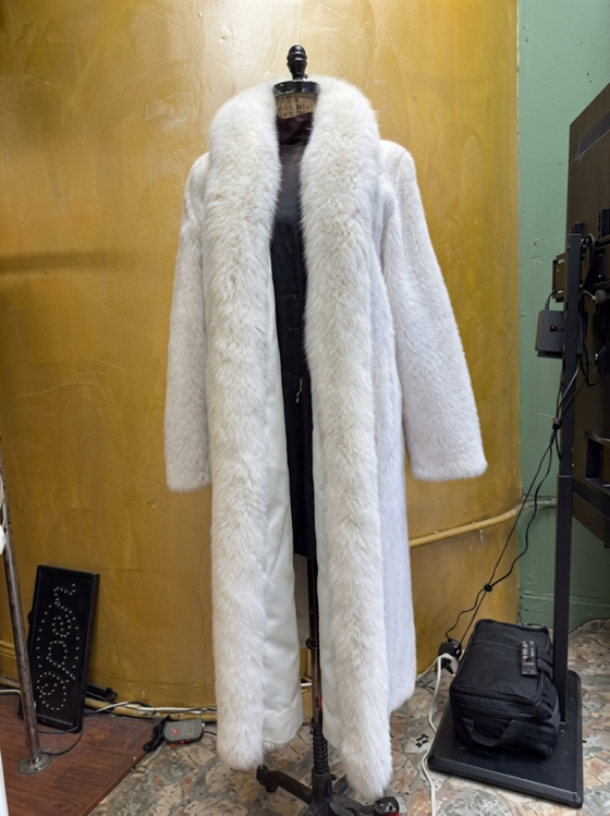 Elegant full-length white fox fur coat on dress form at USA Furs by George Manhattan