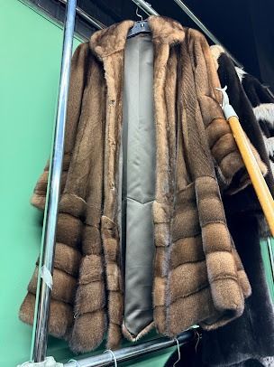 Premium handcrafted brown tiered mink fur coat hanging on rack at USA Furs by George New York