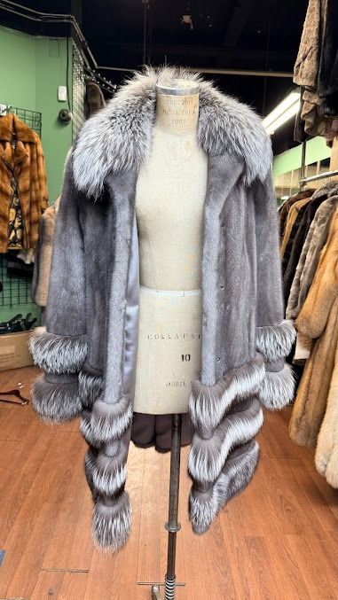 Gray faux-fur coat with striped cuffs displayed at USA Furs by George Manhattan atelier
