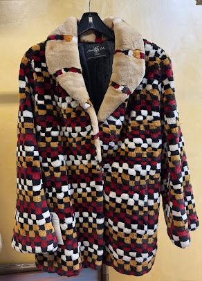 Checkered multi-color fur coat with a plush tan collar displayed at USA Furs by George Manhattan