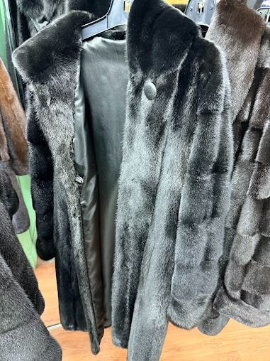 Sleek custom dark charcoal fur coat hanging at USA Furs by George Manhattan