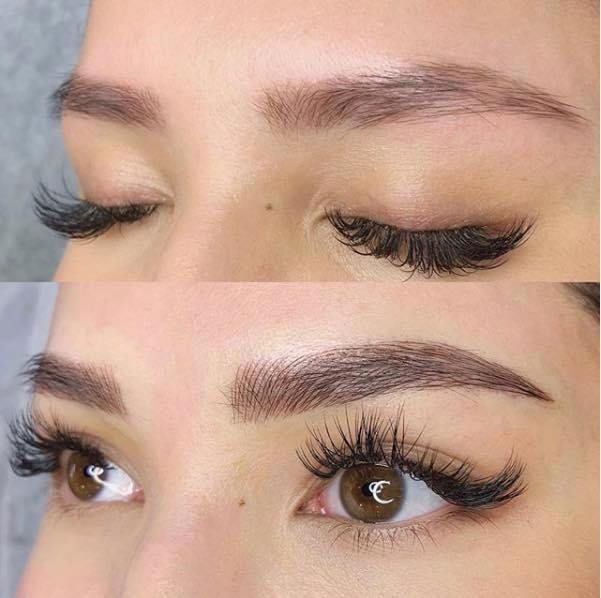 A close up of a woman 's eye with long eyelashes.