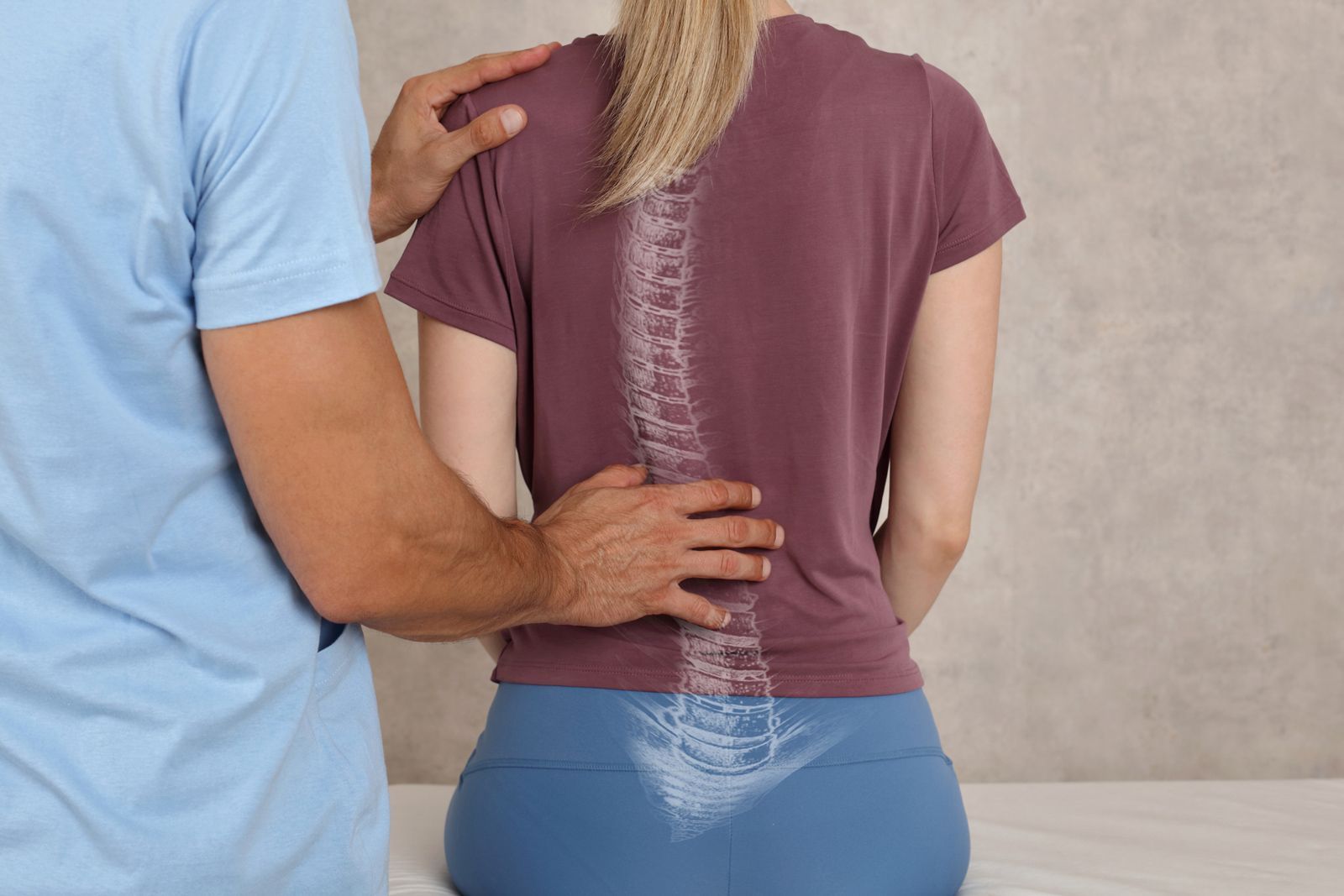 A man is putting his hand on a woman 's back
