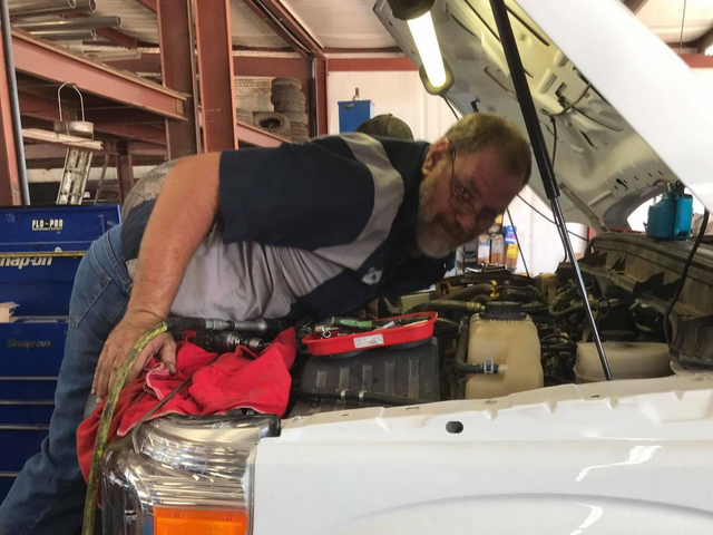 Mechanic Inspecting Engine Bay During Auto Repair | Carthage Service Center and Tires