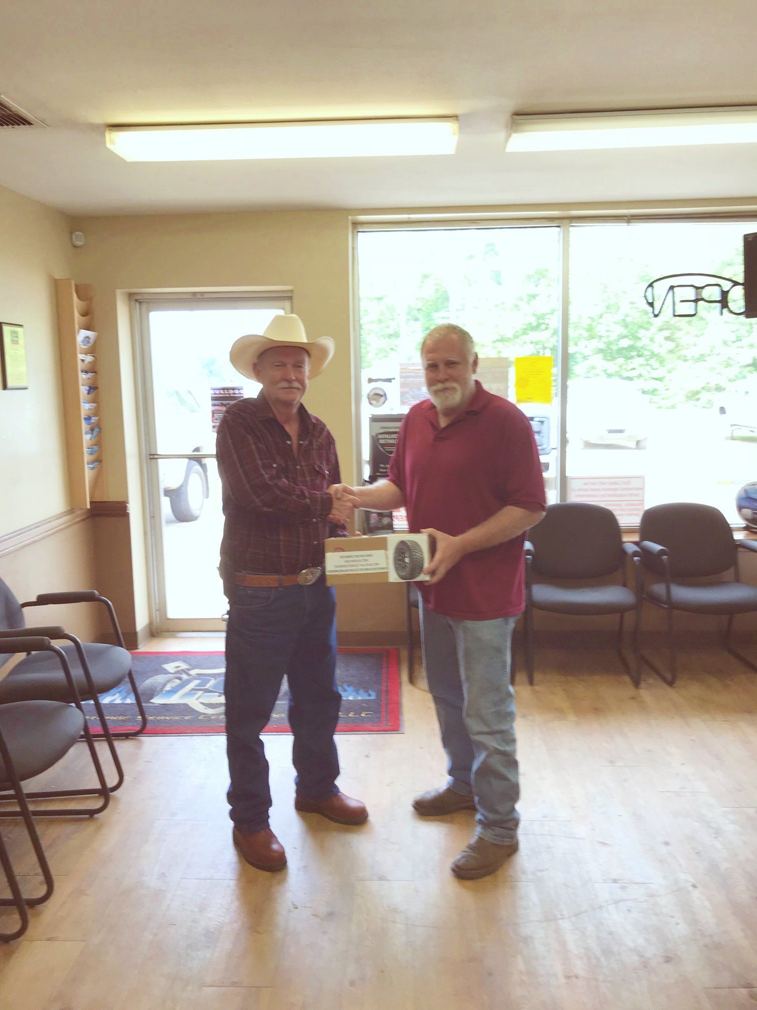 Customer Standing With Team Member Inside Auto Shop Lobby | Carthage Service Center and Tires