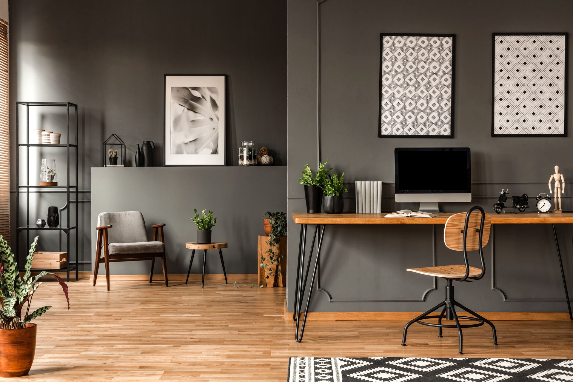 there is a desk with a computer on it in the middle of the room .