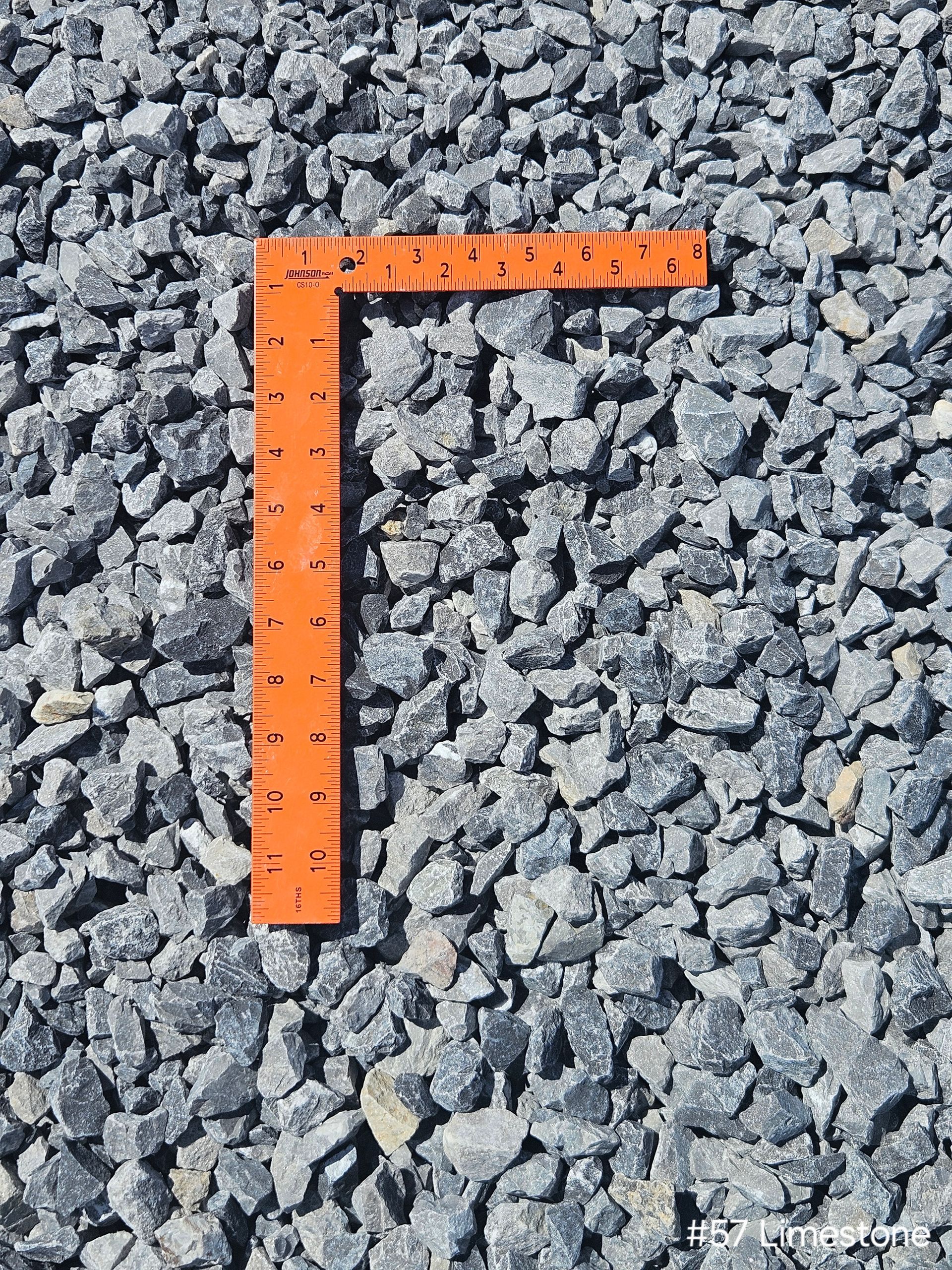 Close-up of a pile of limestone #57 stones from a supplier. Close-up of a pile of limestone #57 stones from a supplier.