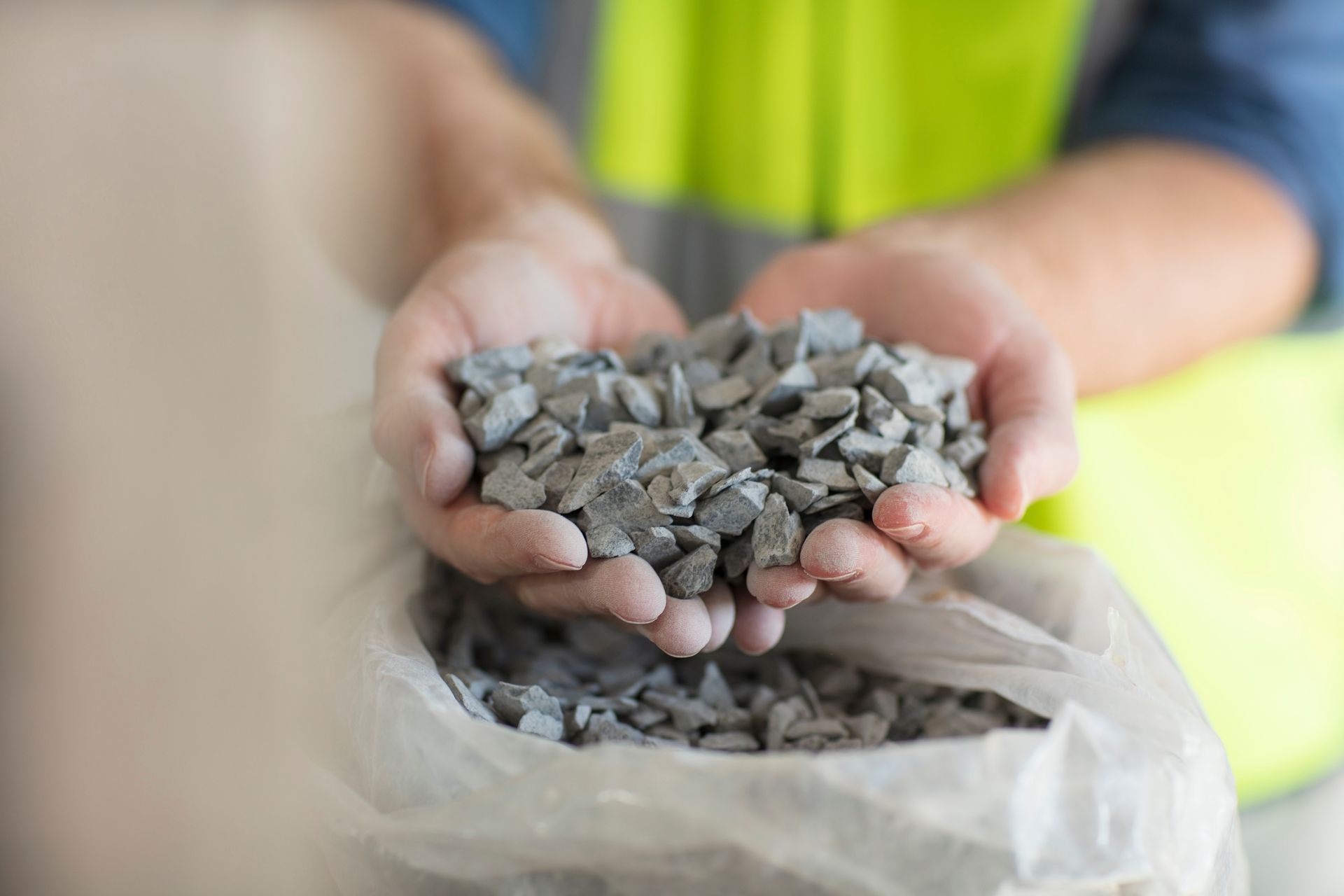Crushed stones showcased in worker’s hand