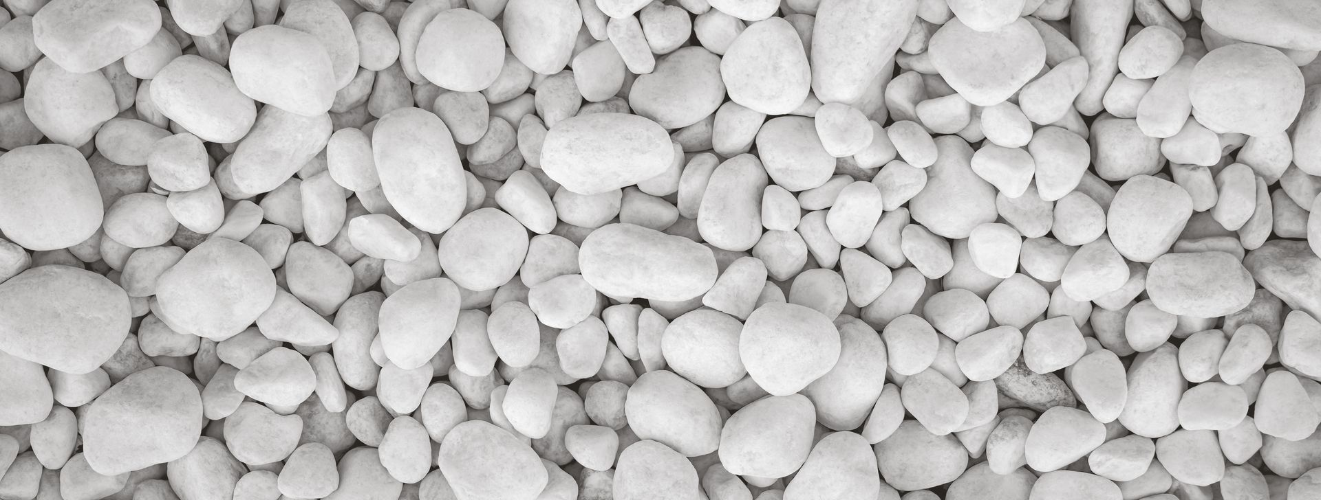 Close-up view of smooth white pebbles arranged tightly together. Close-up view of smooth white pebbles arranged tightly together.