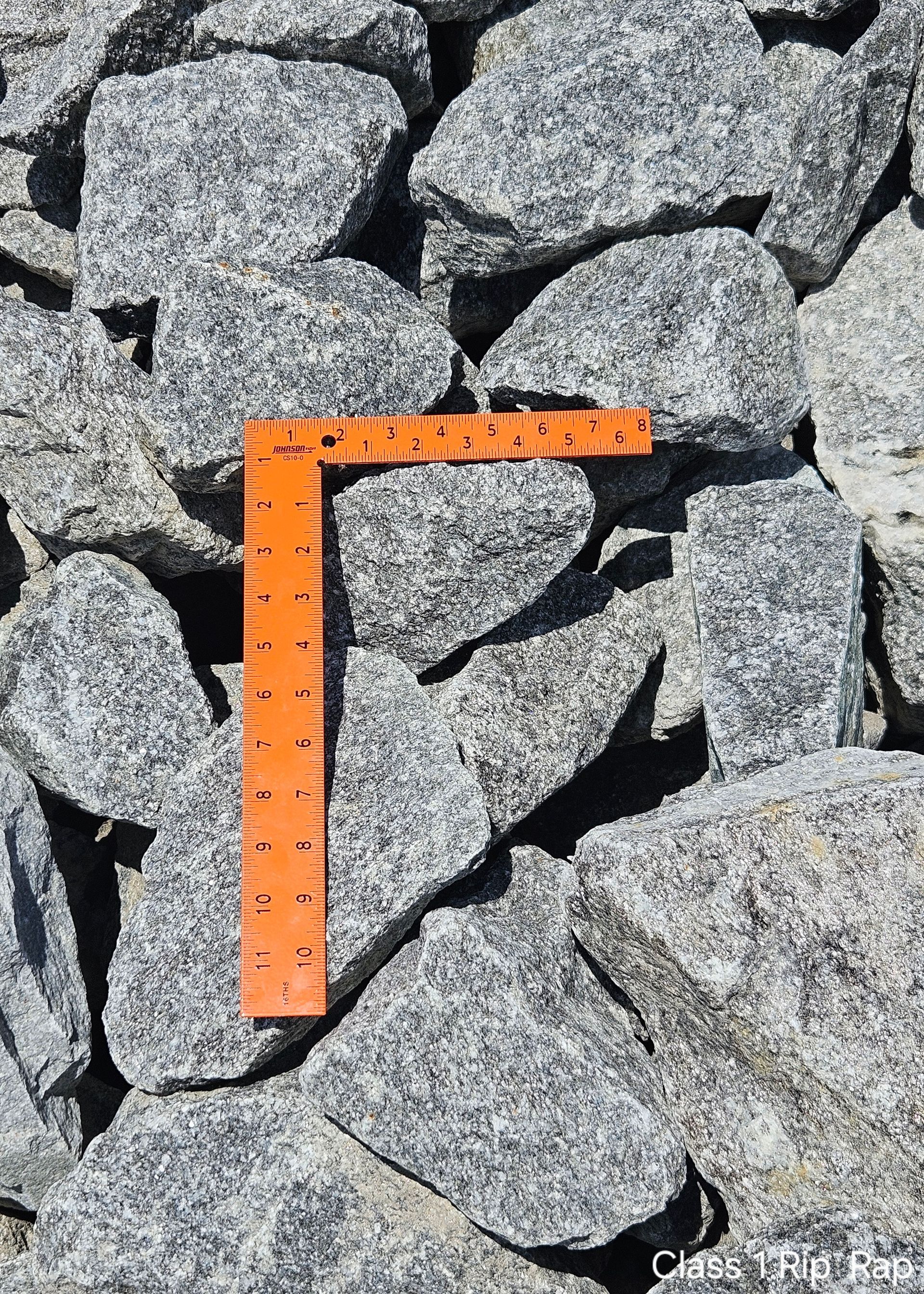 Gray rocks with an orange ruler for scale.