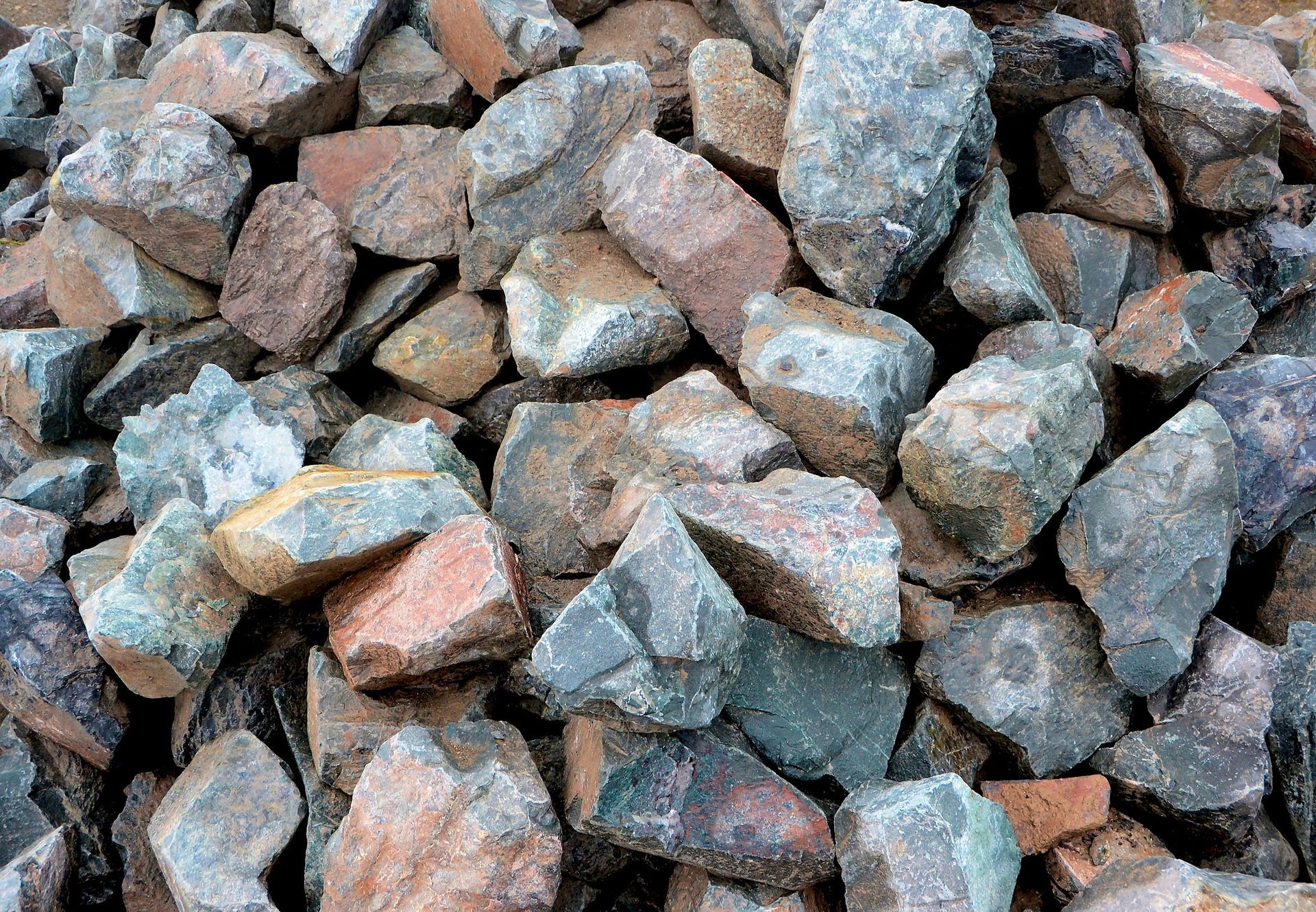 A pile of rocks sitting on top of each other on the ground.