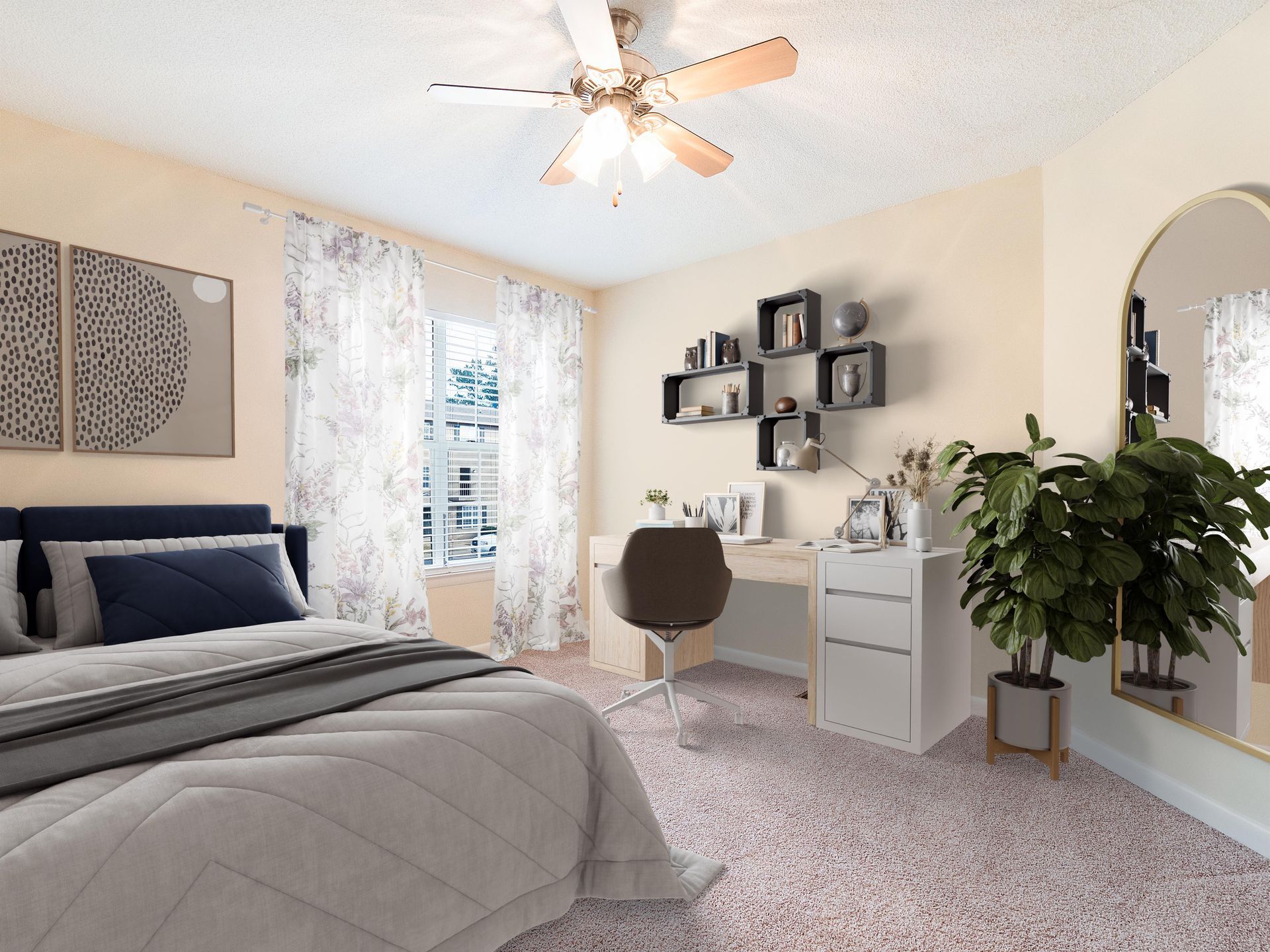 A modern bedroom with a navy blue bed, gray bedding, a white desk, wall shelving, a houseplant, and a large arched mirror.