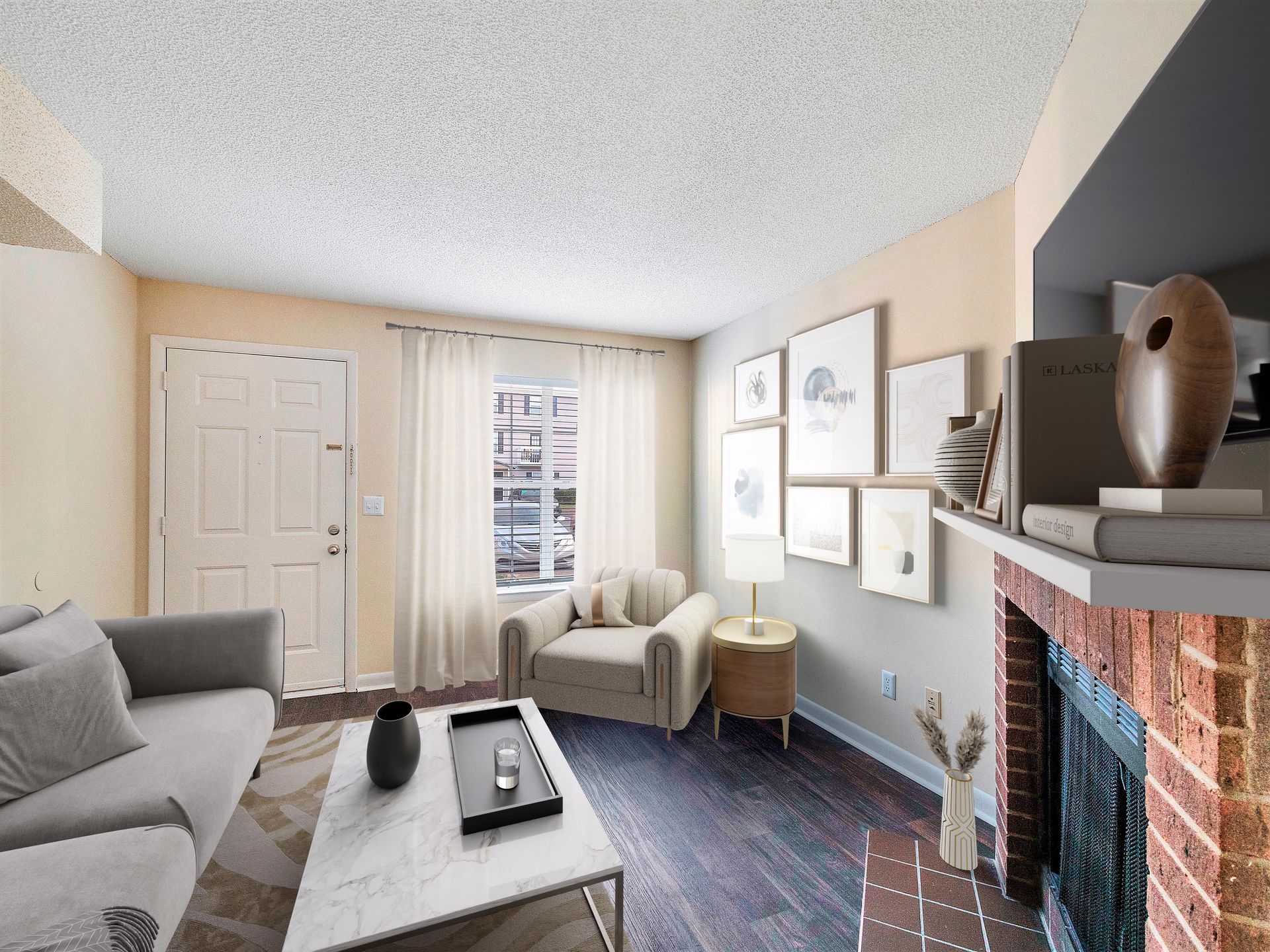 Living room with a gray sofa, white coffee table, cream armchair, gallery wall, and a red brick fireplace.