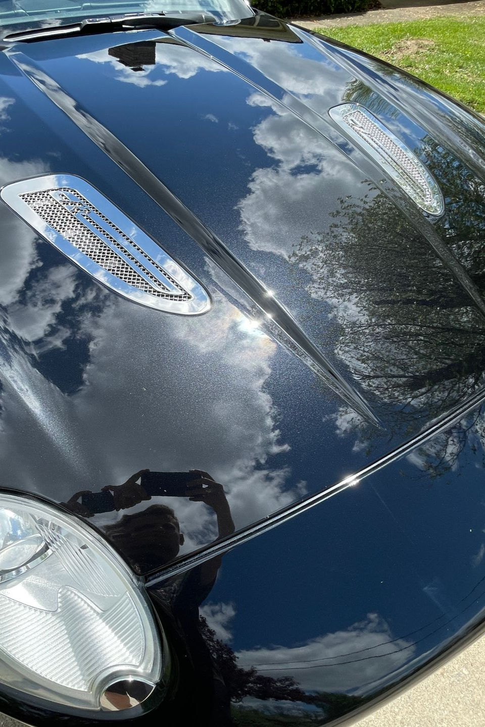 A close up of water drops on the hood of a car