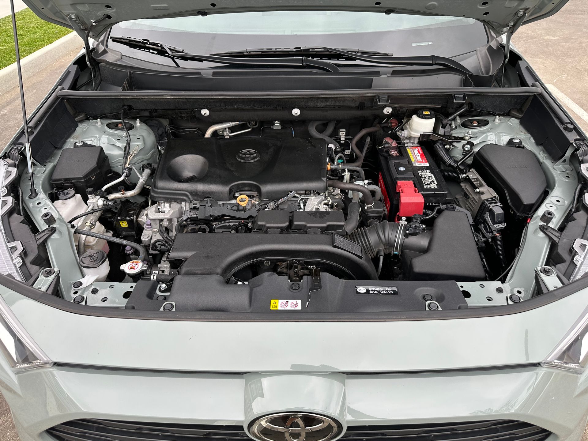 The engine of a toyota rav4 is shown with the hood open.