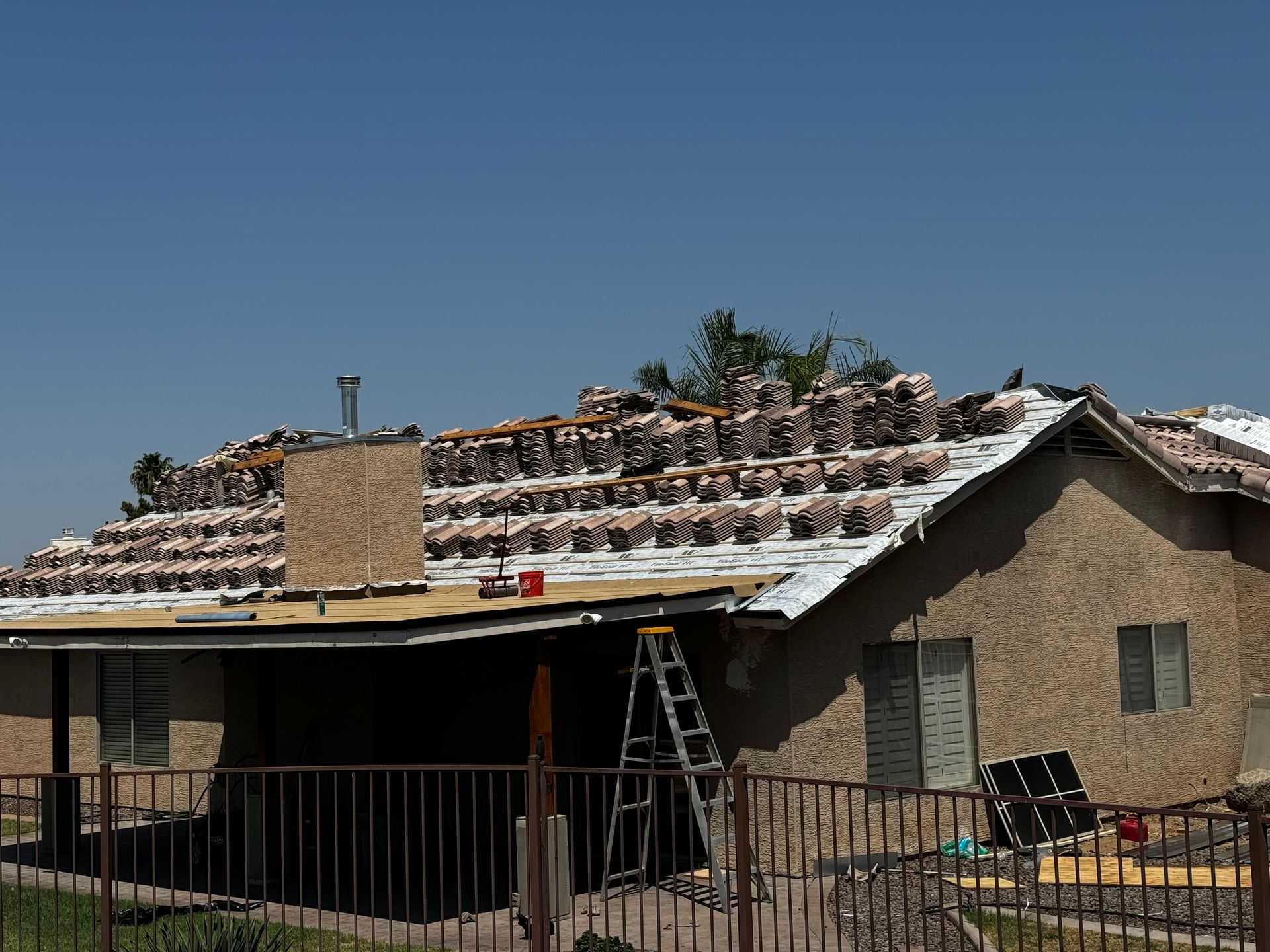 roofing company stacking tiles on roof