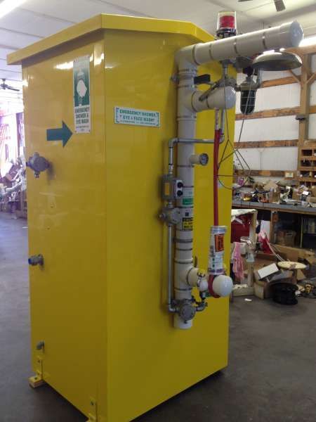 Yellow industrial machine with pipes and valves in a workshop