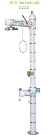 Industrial eyewash and shower safety station with vertical silver pipe and green basin