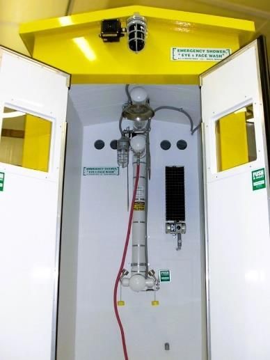 Open white cabinet with yellow top panel and hanging cables inside a lab or equipment enclosure