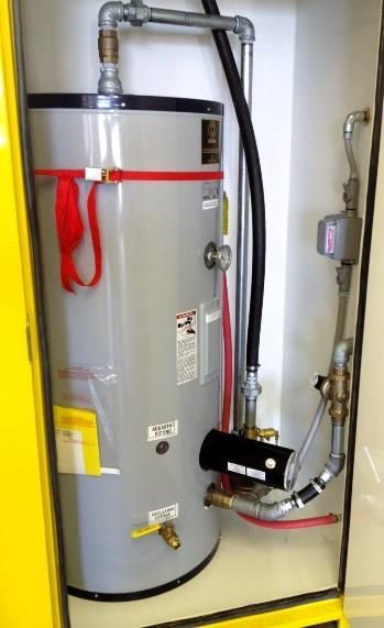 Water heater with connected pipes and valves in a utility closet
