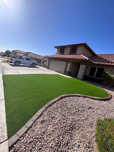 A truck is parked in front of a house with a lush green lawn.