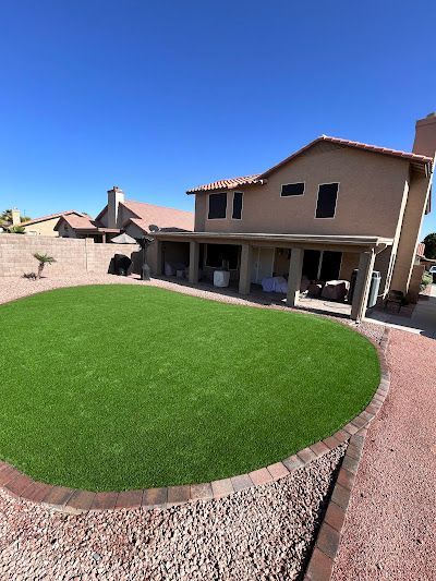 A large house with a lush green lawn in front of it.