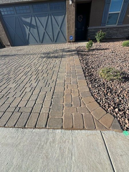 A house with a concrete sidewalk in front of it
