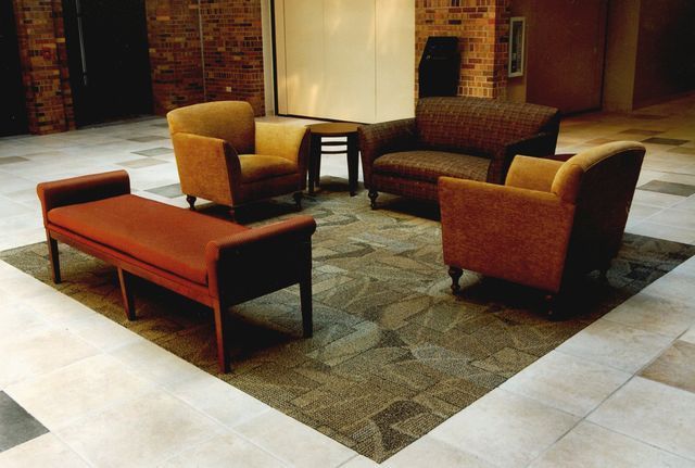 A living room with a couch chairs and a bench