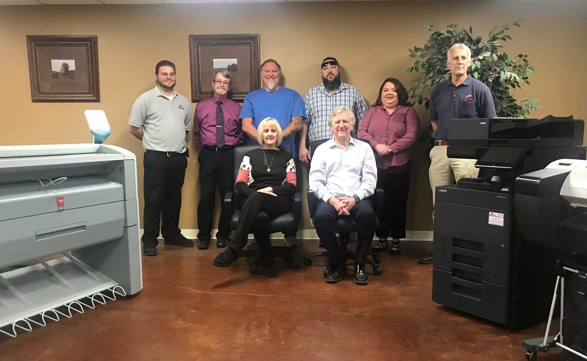 A group of people are posing for a picture in an office.
