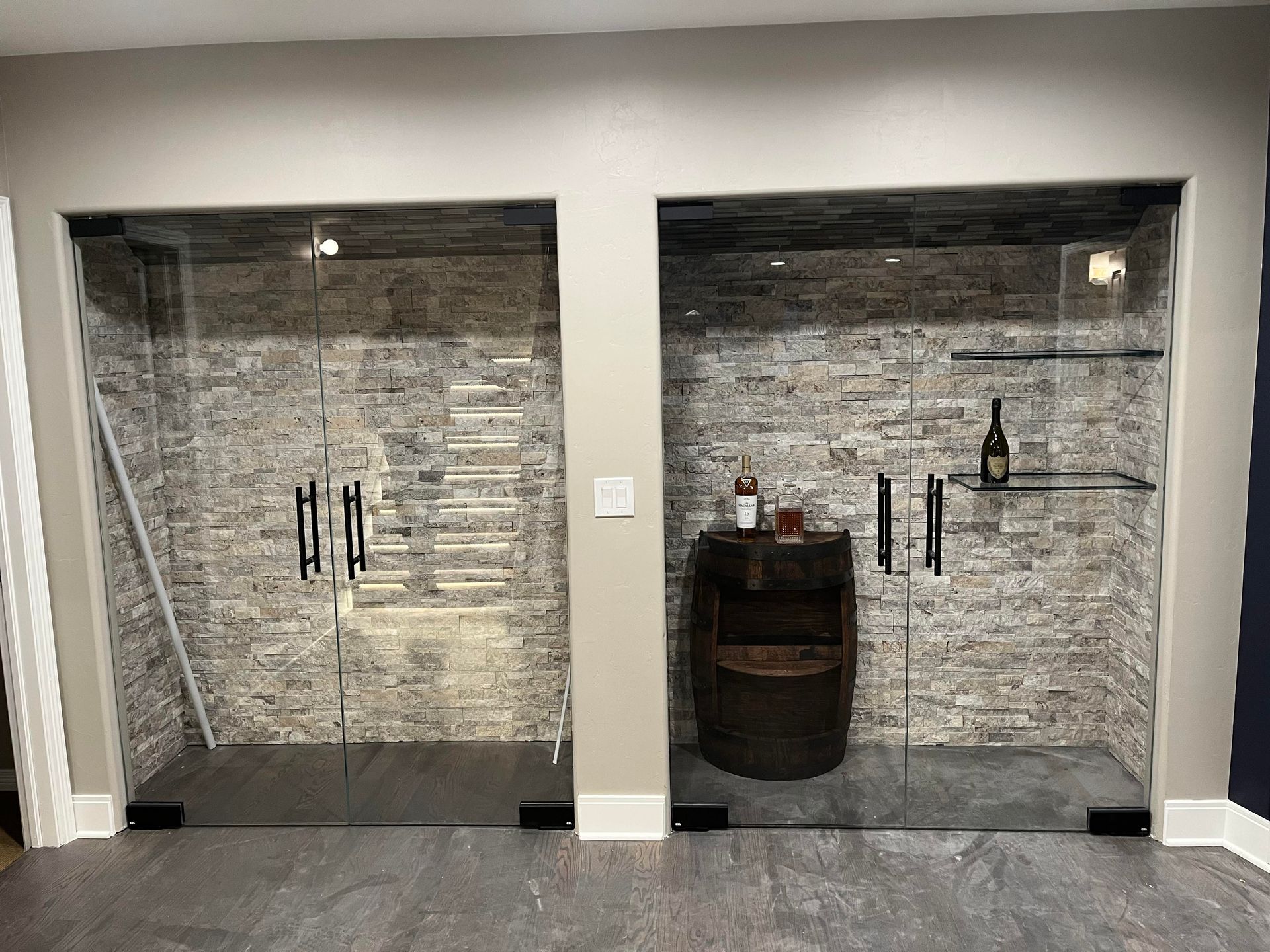 A room with two glass doors and a barrel on a shelf.