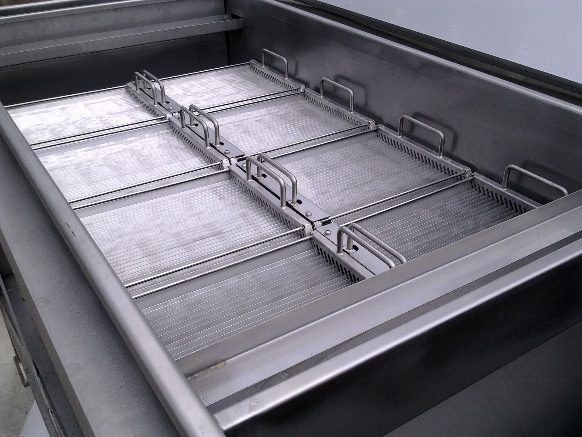 Stainless steel fryer with multiple mesh baskets, suitable for large-scale food preparation.