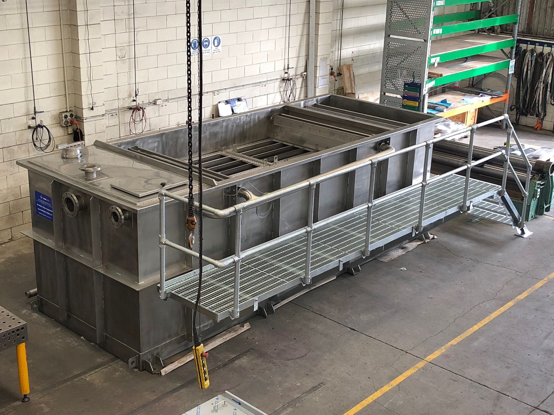 Large industrial metal tank with a grating and walkway.