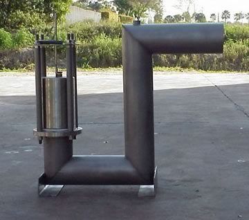 Metal apparatus outdoors with a vertical cylindrical component and a right-angled, horizontal section.