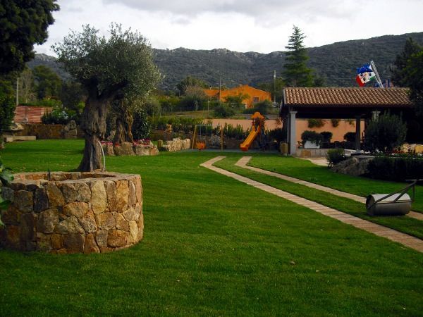 Un pozzo di pietra nel mezzo di un campo verde lussureggiante