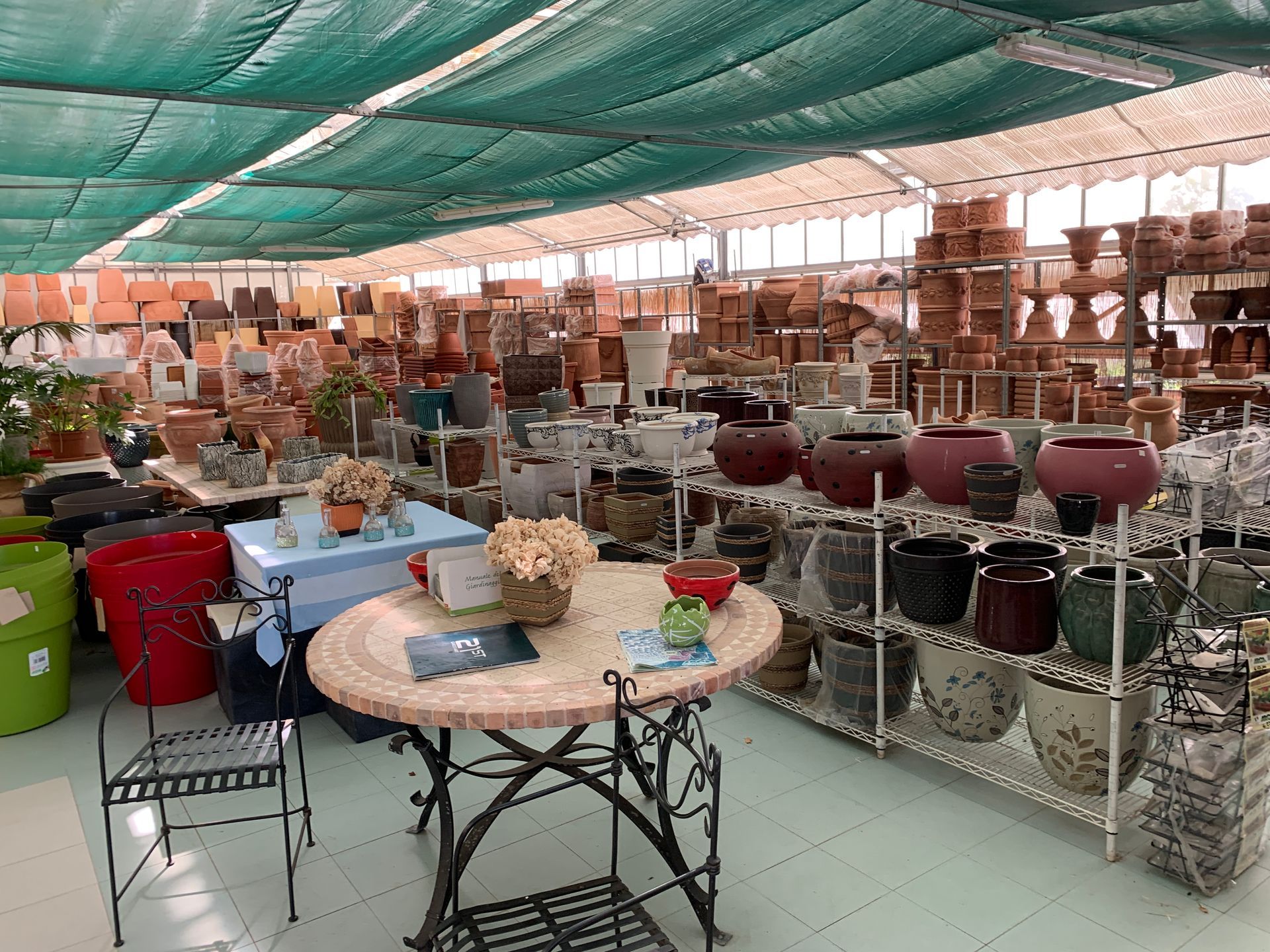 A large room filled with many pots and pans and a table.
