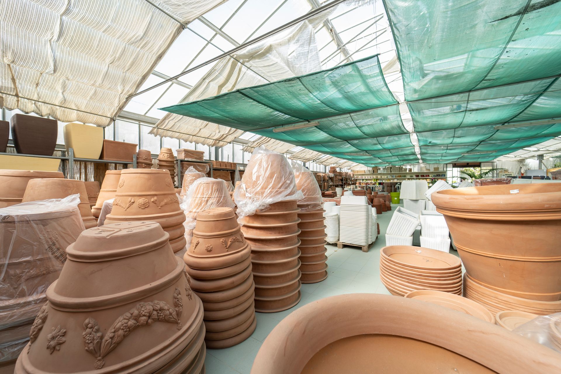 A greenhouse full of pots and containers.
