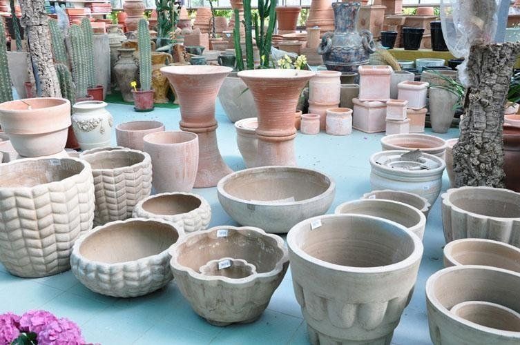 On a table is a pile of terracotta pots