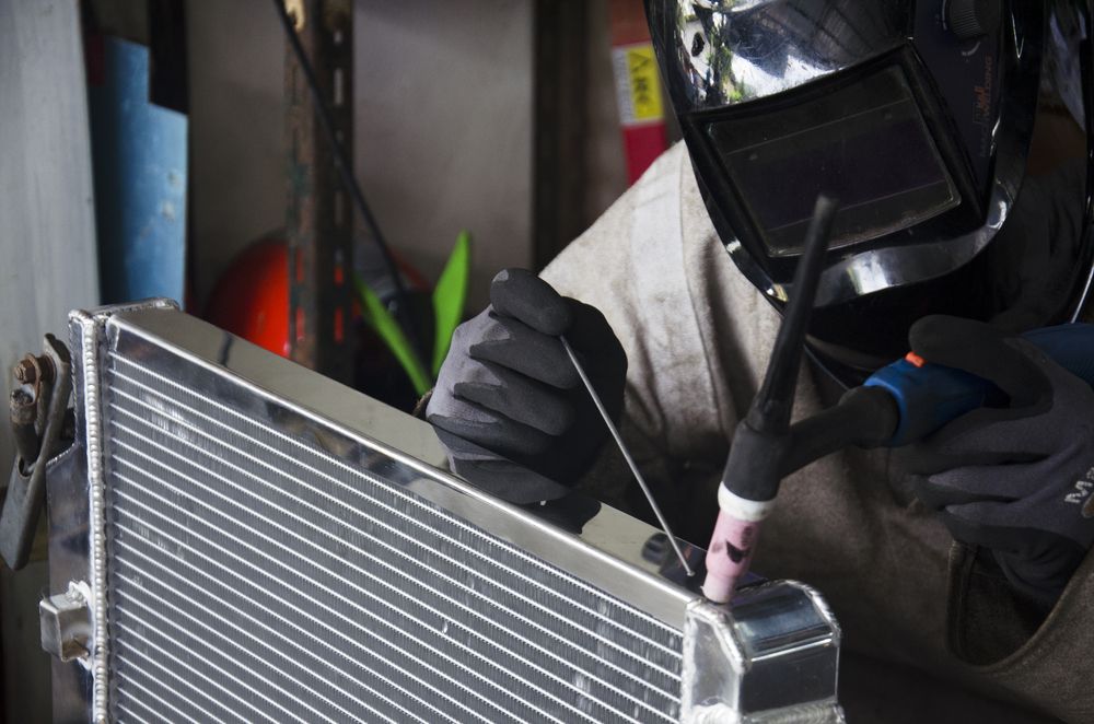 Welder in A Workshop Using a TIG Torch on A Radiator — Wallsend Automotive in Maryland, NSW