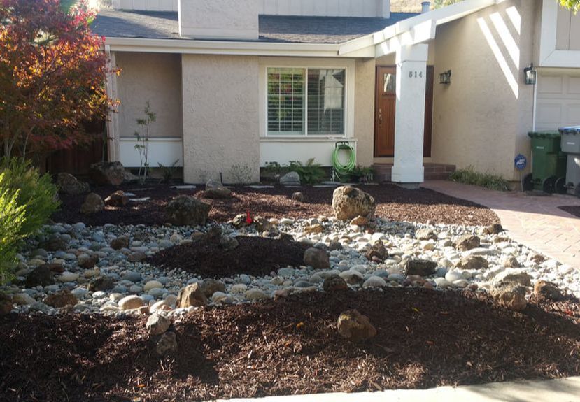 A house with a lot of rocks in front of it