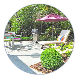 A patio with a purple umbrella and chairs