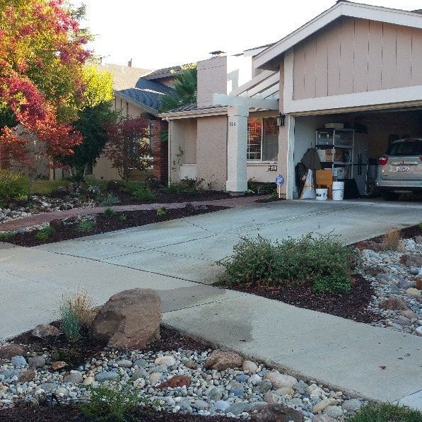 A car is parked in a driveway in front of a house