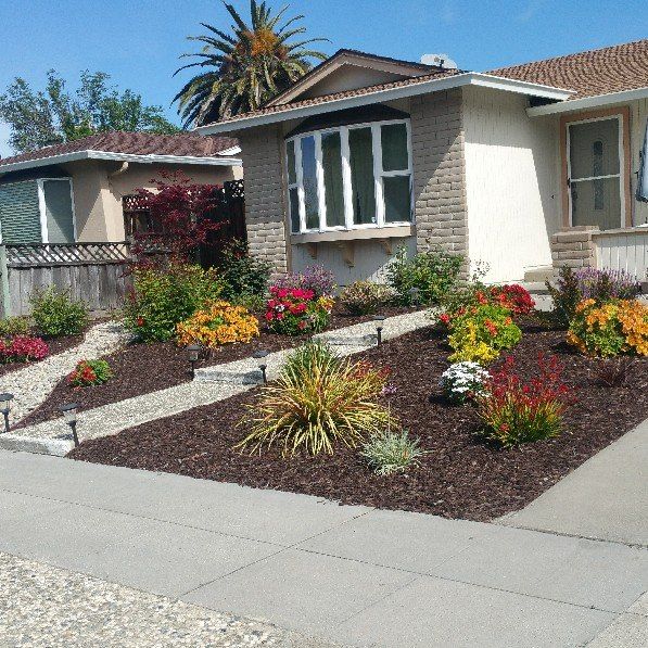 A house with a lot of flowers in front of it