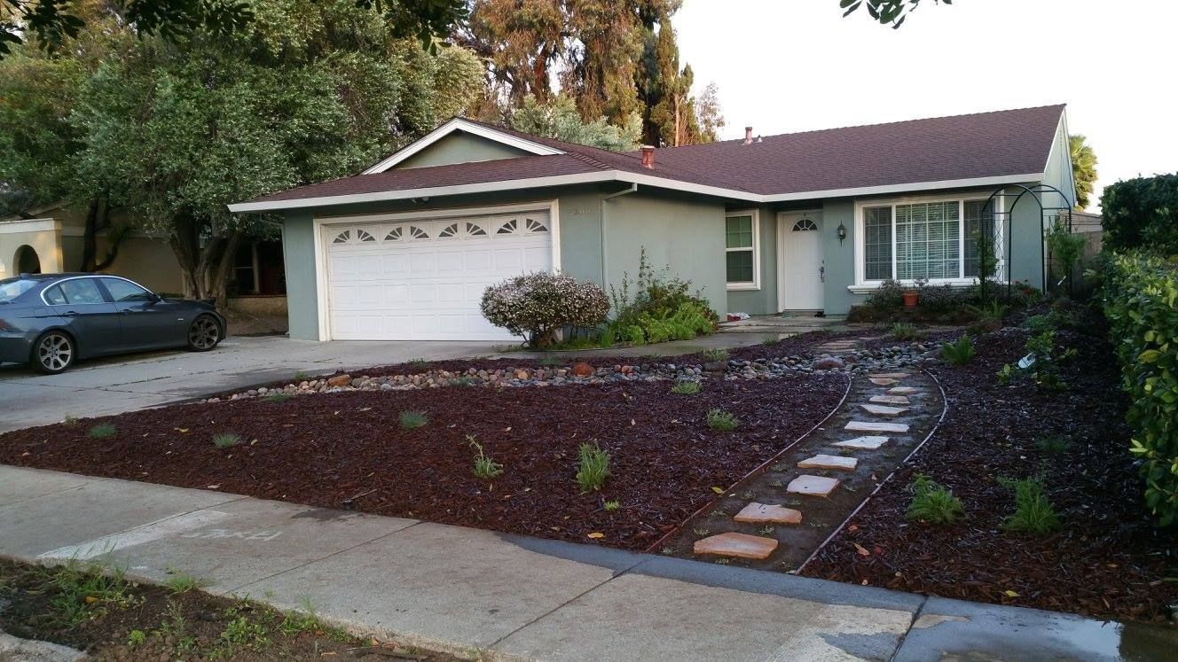 A house with a car parked in front of it
